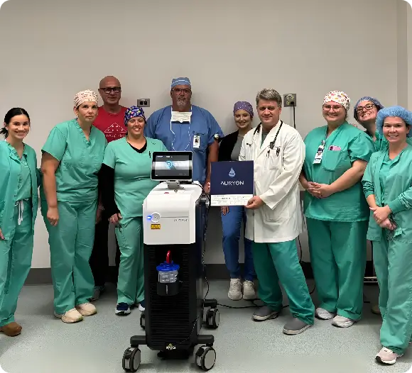 Dr. Patrick Savoy, MD stands with his staff presenting an award recognizing his excellence in surgery and patient centered care at his clinic in Oakdale, LA.